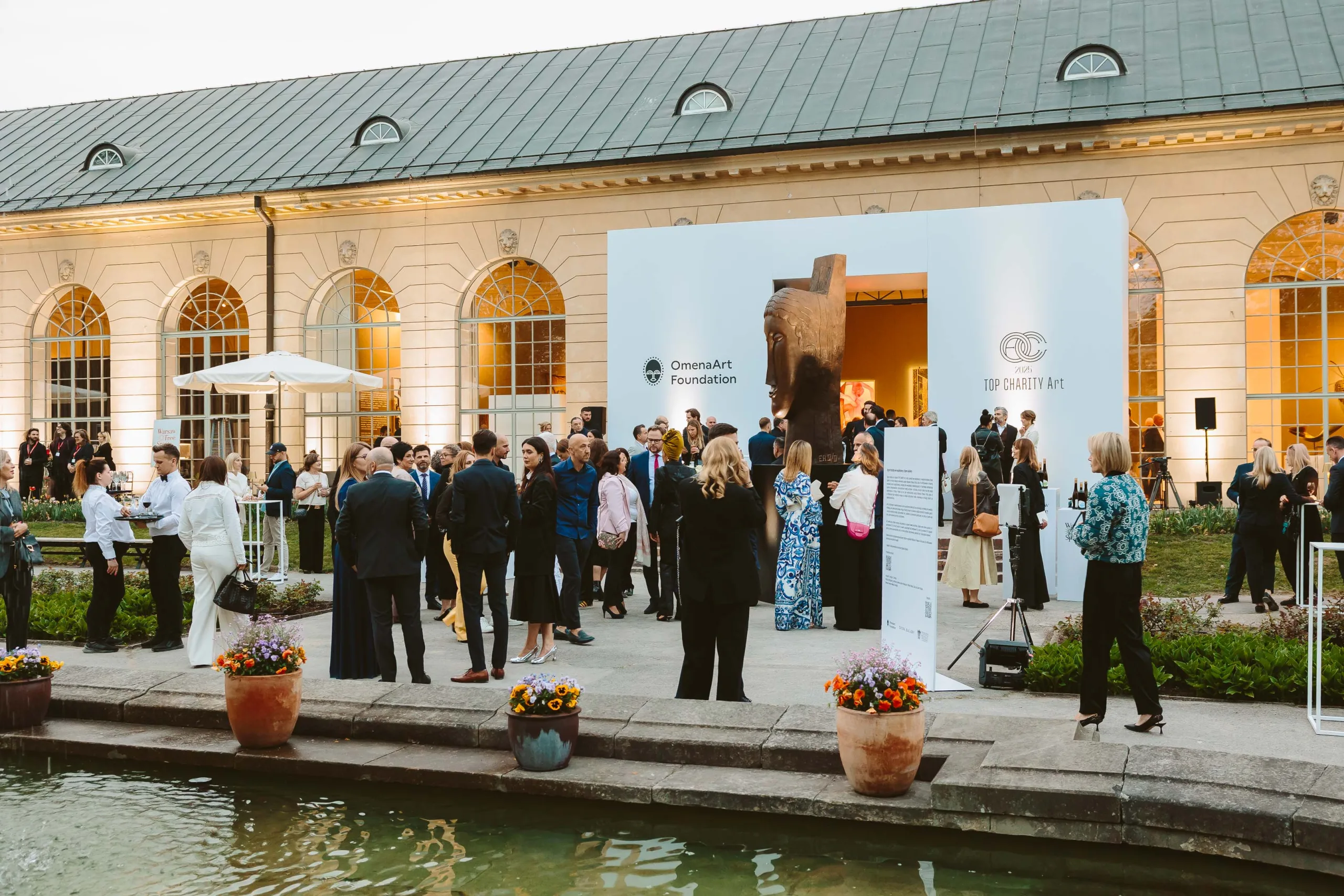 Guests at the photo wall featuring partners' logos during the networking part of the gala